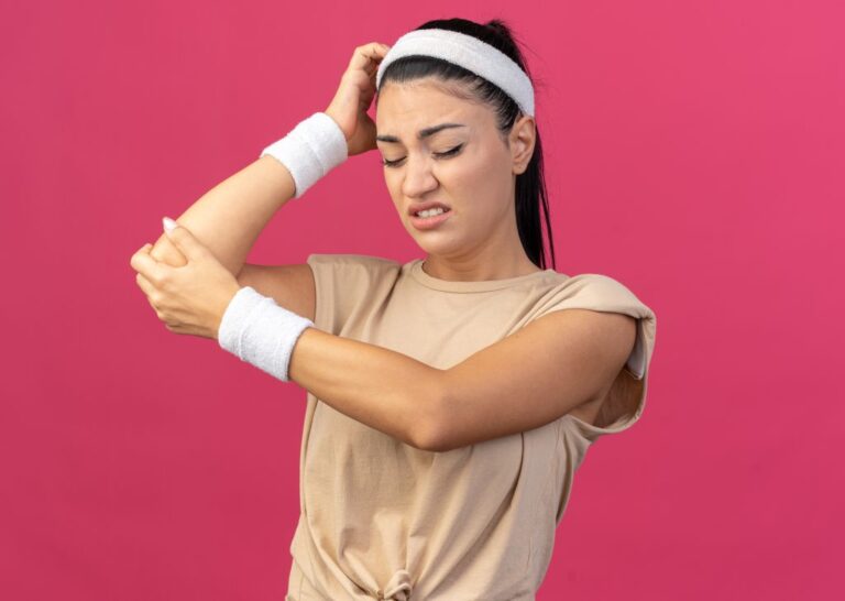 aching-young-caucasian-sporty-girl-wearing-headband-wristbands-touching-head-putting-hand-elbow-with-closed-eyes-isolated-pink-wall-1024x728