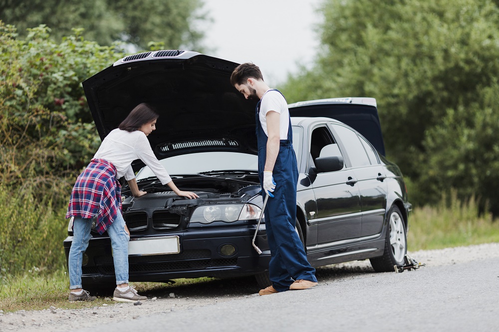 man-woman-checking-car-engine